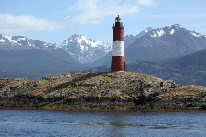 Les Éclaireurs lighthouse in the Beagle Channel, off Ushuaia, with snow on the mountains behind